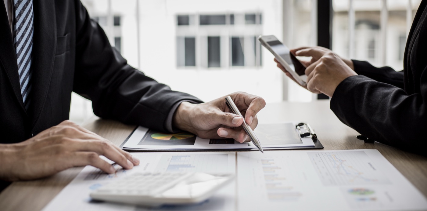 Two people reviewing financial documents