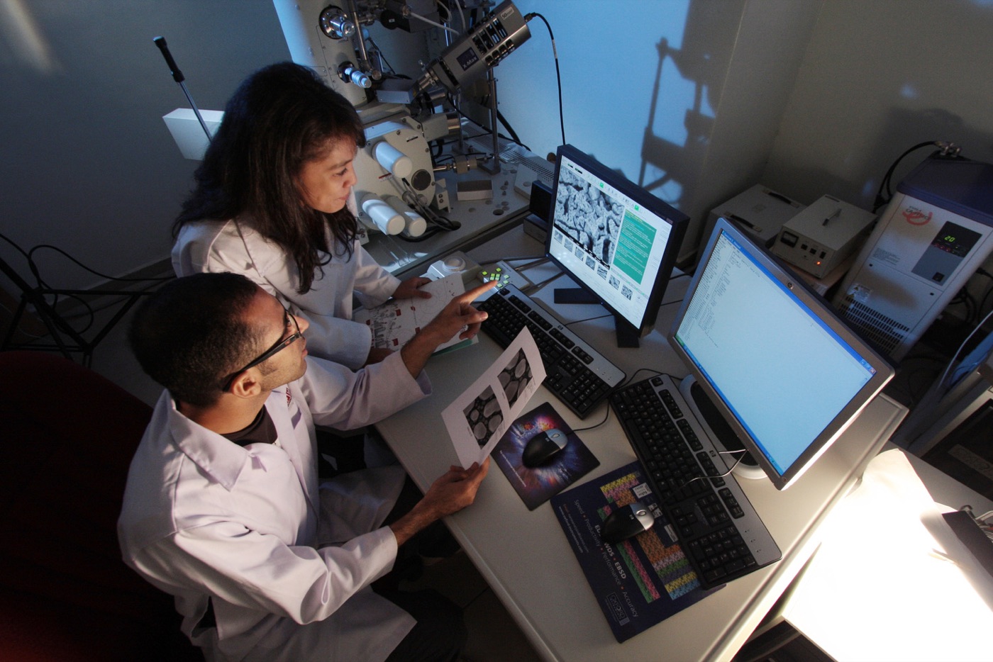 Researchers reviewing data at lab workstations